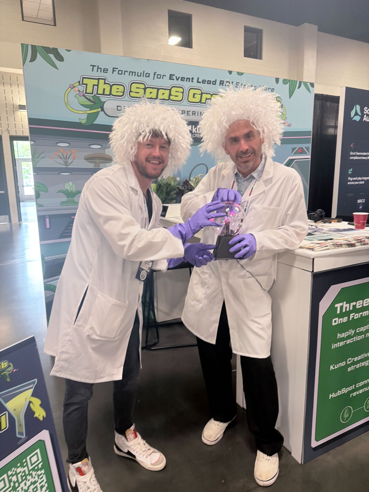 A picture of two Kuno team members dressed as mad scientists at the SaaStock 2026 booth.